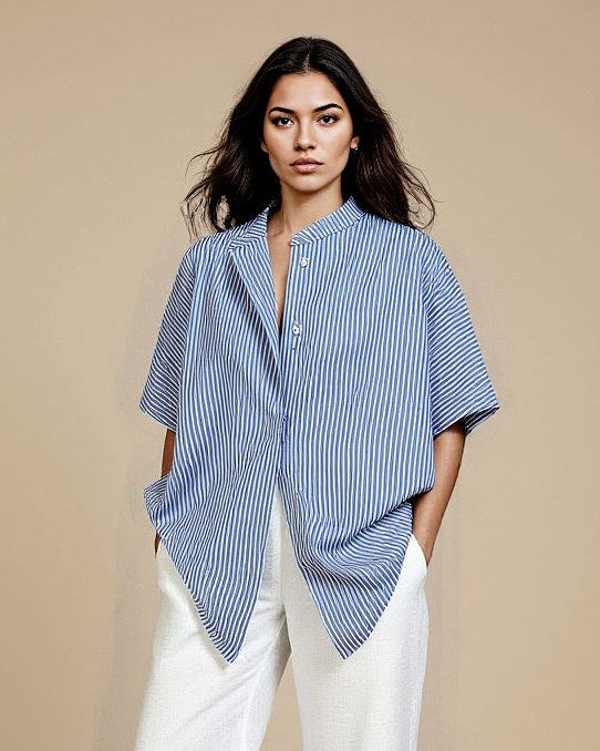 Woman wearing a blue and white striped shirt with a beige background